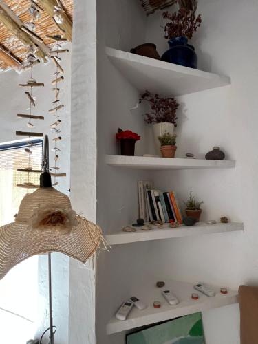 a living room with white shelves and a television at Los Perales in Sorbas
