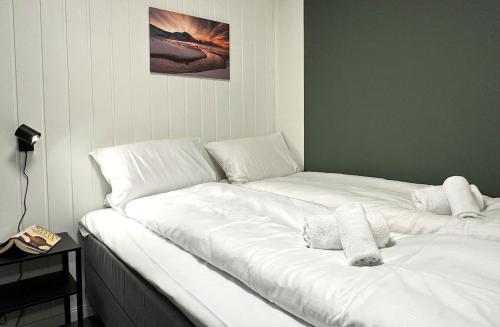 a bed with two white pillows on it in a room at City apt with 2 bedrooms and kitchen - Hydrus in Tromsø
