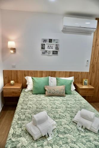 a bedroom with a bed with a world sign on it at Casa Tapada do Bento II- Albufeira in Albufeira