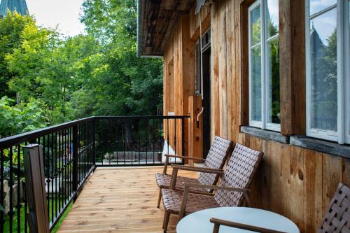 a porch with two chairs and a table at Podgórska in Lanckorona