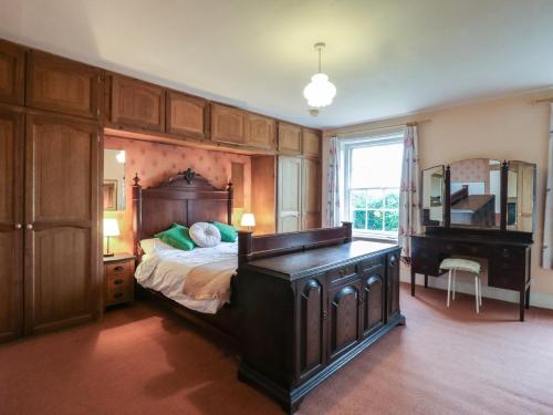 a bedroom with a large bed and a piano at Chilton Manor House in Murston
