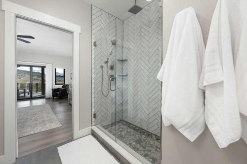 a bathroom with a shower with a glass door at Saddle Ridge, 0021 in Granby
