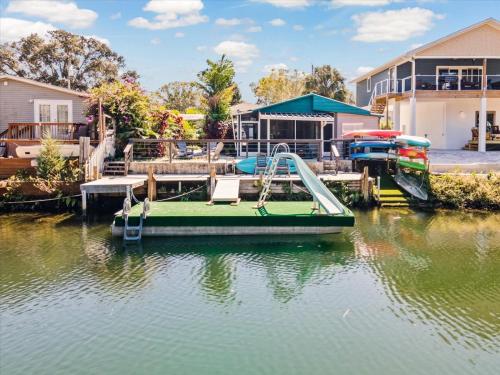 a green boat with a slide in the water at The Hideaway at Weeki Wachee in Weeki Wachee