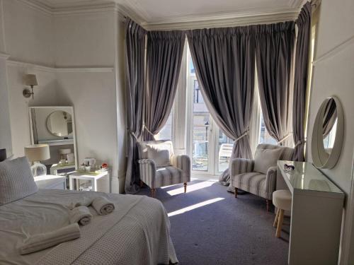 a bedroom with a bed and a large window at Southcliffe hotel in Bridlington