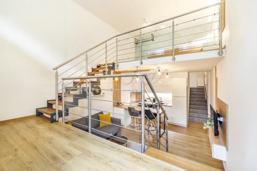 a staircase in a house with a glass railing at Apartmán Dub in Golčŭv Jeníkov