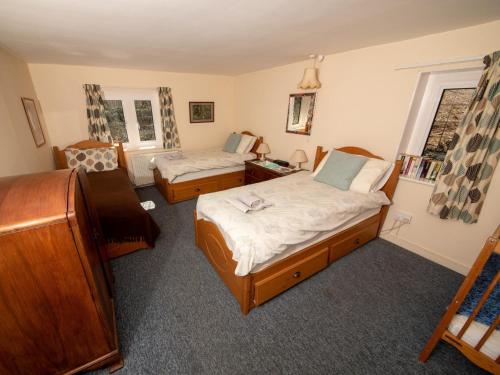a bedroom with two beds and a window at 2 Bed in Studland DC069 in Studland