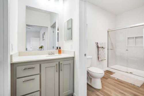 a bathroom with a sink and a toilet and a mirror at Privately Secluded Guesthouse in Fremont