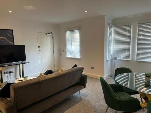 a living room with a couch and a table at The Cassius Apartment Huntingdon in Huntingdon