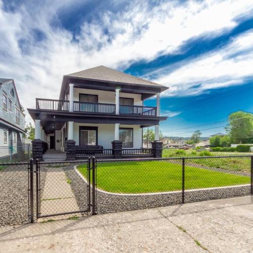 a house with a fence in front of it at Historic 3 Bed 1 bath Near Downtown Spokane in Spokane