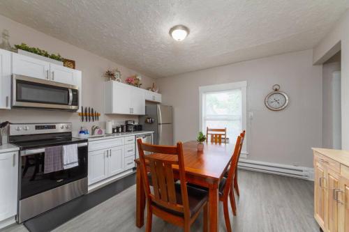 a kitchen with a wooden table and a dining room at Historic 3 Bed 1 bath Near Downtown Spokane in Spokane