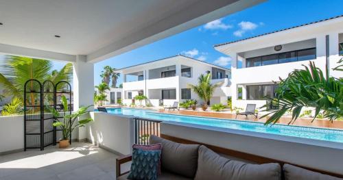 a villa with a swimming pool in front of a house at Casa di Chibi Chibi - Brand new apartment with pool close to the beach in Jan Thiel