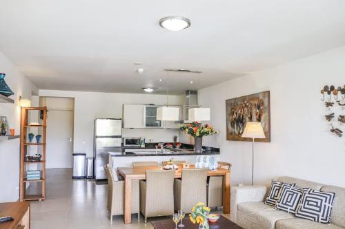 a living room with a table and a kitchen at Azure Haven in Willemstad