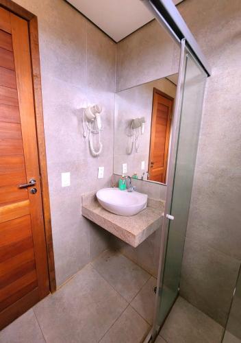 a bathroom with a sink and a shower at Pousada Recanto in Fernando de Noronha