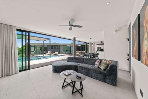 a living room with a couch and a table at Villa Sea View Luxury in Willemstad