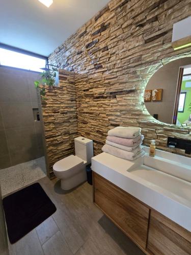 ChantepecにあるLa casita Blanca, it has everythingの洗面台と石の壁のあるバスルーム