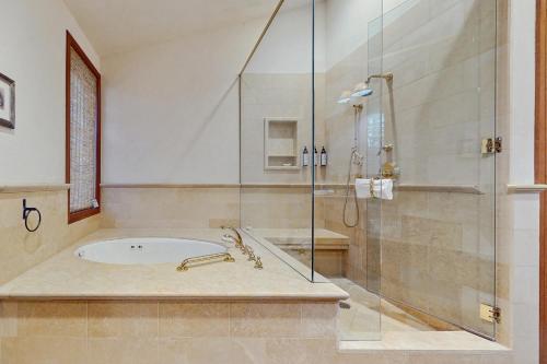 a bathroom with a tub and a glass shower at Aspen Meadows Resort 111 in Aspen