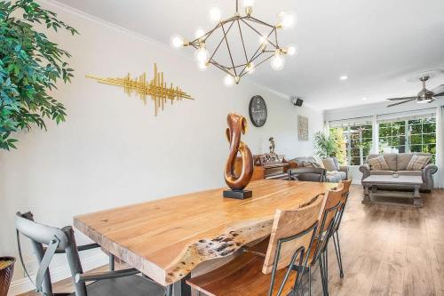 a dining room with a wooden table and chairs at Charming Villa with Backyard Oasis Close to Beach in Laguna Hills