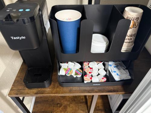 a coffeemaker sitting on a table next to a coffee maker at Signature Suite in Orlando
