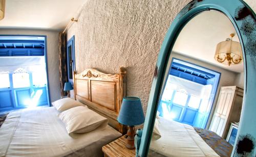 a bedroom with a large mirror and a bed at Villa Fanti in Cesme