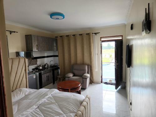 埃尔多雷特Hom-Feel的一间带床的卧室和一间带桌子的厨房