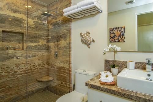 a bathroom with a shower and a toilet and a sink at Beautiful 2 bedroom condo Encantame Tower E 802 in Puerto Peñasco