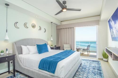 a bedroom with a bed and a view of the ocean at Beautiful 2 bedroom condo Encantame Tower E 802 in Puerto Peñasco