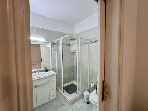 a bathroom with a shower and a sink and a toilet at Casa Alba in La Mareta