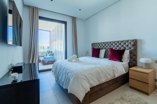 a bedroom with a large bed and a large window at C07- Pestana - Luxury Hotel Flat - Terrace - Pool in Casablanca