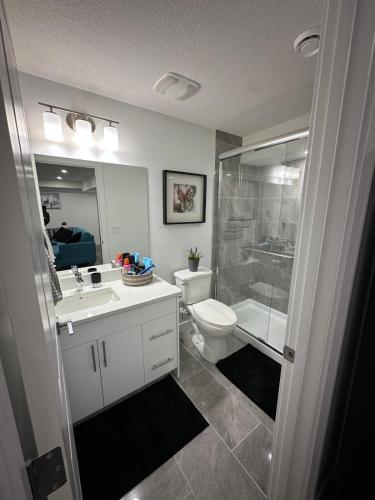 a bathroom with a toilet and a sink and a shower at Guest Suite with Private Entry in Calgary in Calgary