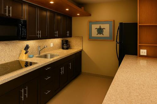 a kitchen with a sink and a refrigerator at Sugar Beach 416 - MCH in Kihei