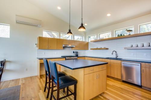 a kitchen with wooden cabinets and a black counter top at Ocean View of Rocky Shore! Yachats! Shorely Blessed in Yachats