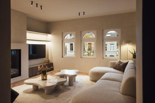 a living room with a couch and a tv at LEO - Antwerp in Antwerp