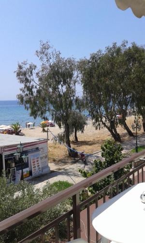 a view of a beach with trees and the ocean at Seaside Studios in Paralia Dionysiou