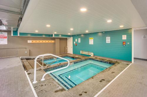 a large swimming pool in a gym with at Walk to Lifts and Village! Killington Mountain Condo in Killington