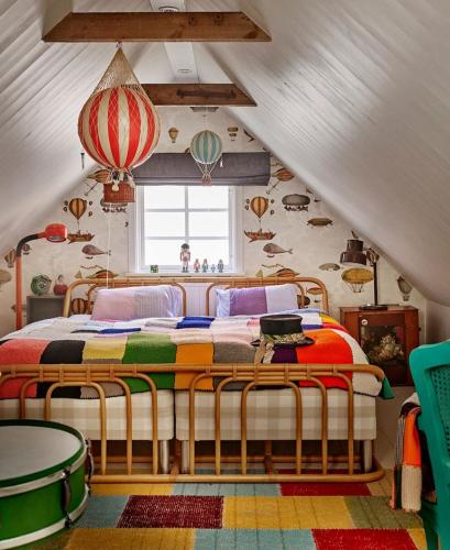 a bedroom with a bed in a attic at Revolverhotel in Visby