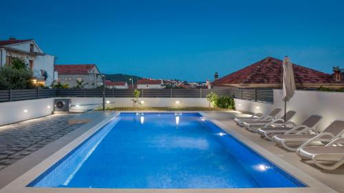 a swimming pool on the roof of a house at Apartments Apollo in Trogir