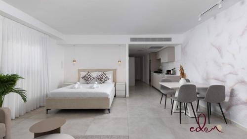 a bedroom with a bed and a table and chairs at Designer suite in Sea Side complex - By Edomlux in Eilat