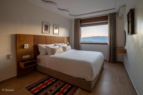 a hotel room with a bed and a window at Ain Chaouen in Chefchaouene