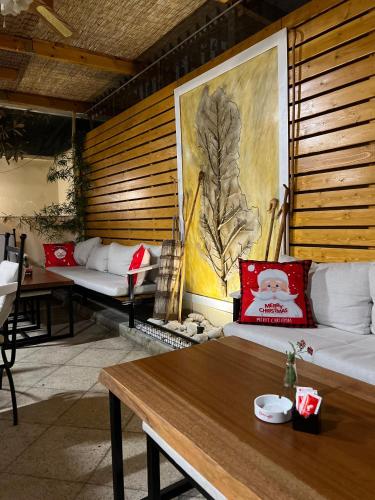 a living room with two couches and a table at Hotel Akropoli in Tirana