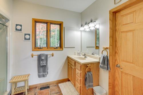 a bathroom with a sink and a mirror at All-Season Adventures! Chicaugon Lakefront Gem in Mapleton