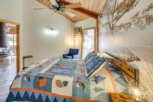 a bedroom with a bed and a painting on the wall at All-Season Adventures! Chicaugon Lakefront Gem in Mapleton