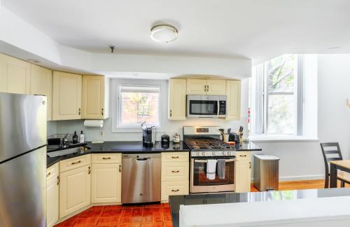 a kitchen with yellow cabinets and a stove top oven at Modern 3BR Townhouse with Private Rooftop & Parking Minutes to NYC in Hoboken