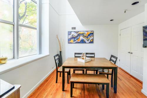 a dining room with a wooden table and chairs at Modern 3BR Townhouse with Private Rooftop & Parking Minutes to NYC in Hoboken