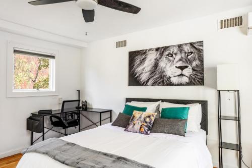a bedroom with a bed with a picture of a lion at Modern 3BR Townhouse with Private Rooftop & Parking Minutes to NYC in Hoboken