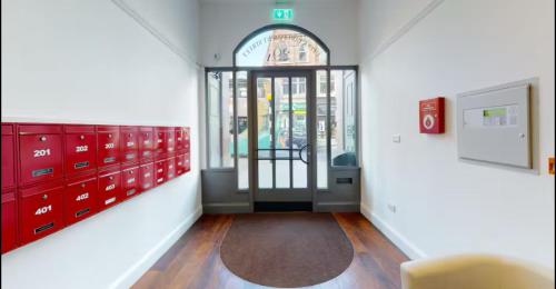 a room with red lockers and a door with a rug at Heart of Notts, Spacious Studio, Great City Views in Nottingham