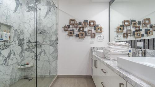 a bathroom with a shower and a sink at Encantame Towers Velero 901 in Playa Encanto