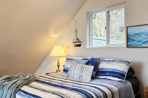 a bedroom with a bed and a window at Ocean View in Yachats! Dog Friendly! Ya-Hut in Yachats