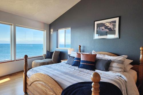 a bedroom with a bed with a view of the ocean at Spectacular Ocean Views! Whaley Nice in Yachats