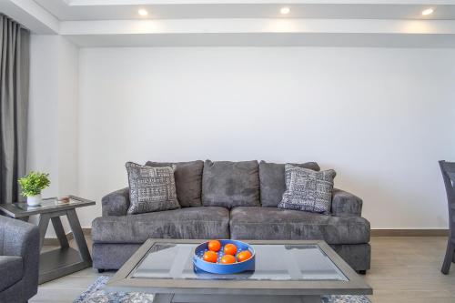 a living room with a couch and a bowl of oranges at Panoramic beach front condo Verano 1703 in Puerto Peñasco