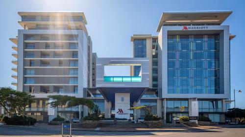 two tall buildings in front of a parking lot at CENTURY CLUB - Luxury Apartment Hotels in Cape Town